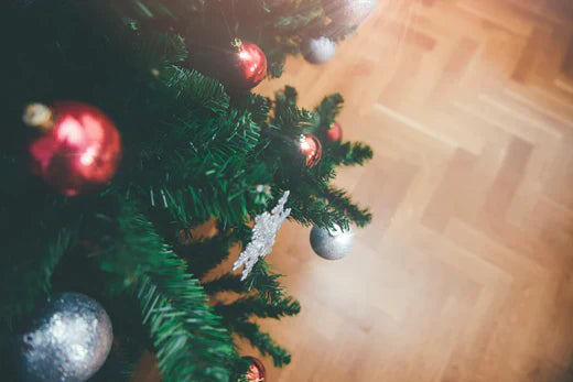 Photo of Christmas Tree on wood flooring.
