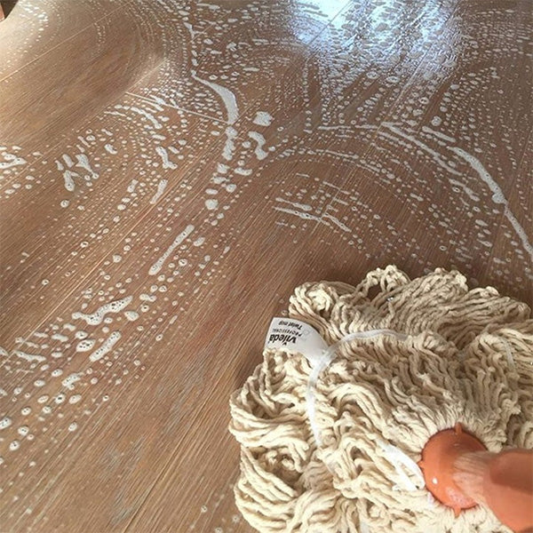 Image of wood floors being cleaned with WOCA Natural soap and cotton head swep mop.